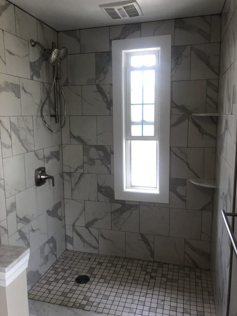 Walk in tile shower, window done with PVC trim for wet location