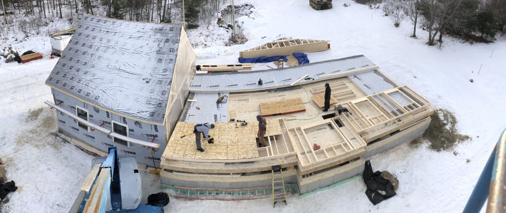 aerial photo of construction workers building a custom house